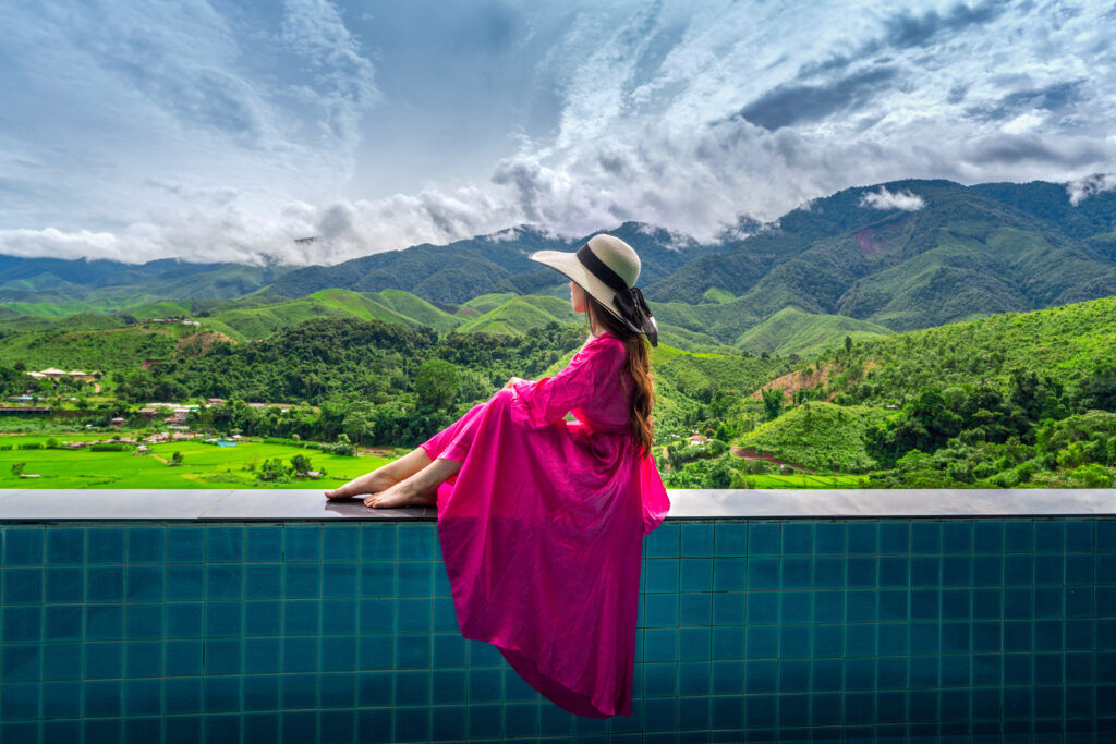 Woman enjoying rice terrace viewpoint and green forest